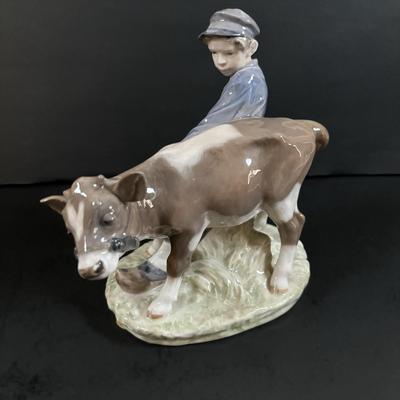 LOT 102: Royal Copenhagen Figurine #772: Boy with Stubborn Calf