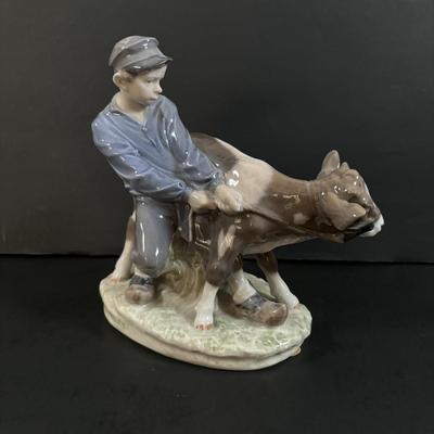 LOT 102: Royal Copenhagen Figurine #772: Boy with Stubborn Calf