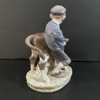 LOT 102: Royal Copenhagen Figurine #772: Boy with Stubborn Calf