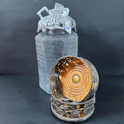 LOT 203: Arthur Court Grape Cluster Canister, Ragazzi & Co. Bottle Stoppers, Grape Cluster Bottle Coasters, Black Stemware w/Matching...