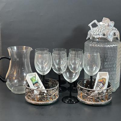 LOT 203: Arthur Court Grape Cluster Canister, Ragazzi & Co. Bottle Stoppers, Grape Cluster Bottle Coasters, Black Stemware w/Matching...