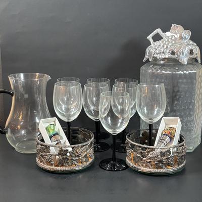 LOT 203: Arthur Court Grape Cluster Canister, Ragazzi & Co. Bottle Stoppers, Grape Cluster Bottle Coasters, Black Stemware w/Matching...