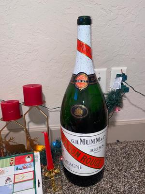 CHRISTMAS DECORATIONS, ALONG WITH THE BIGGEST CHAMPAGNE BOTTLE WE’VE EVER SEEN!