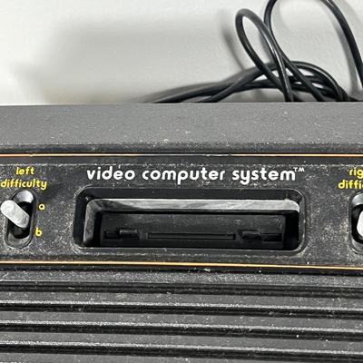 LOT 85L: Vintage Atari 2600 Console, Controller, Paddles and Games in Case
