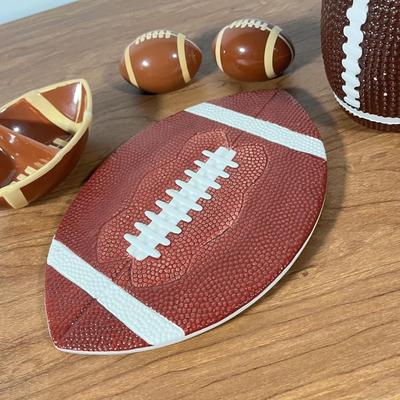 LOT 100L: Football Themed Home Decor, Party Essentials, Serving Pieces, Football-Shaped Crockpot and More