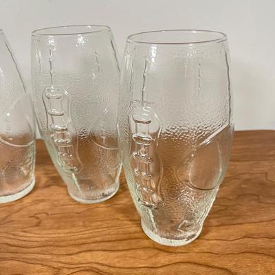 LOT 100L: Football Themed Home Decor, Party Essentials, Serving Pieces, Football-Shaped Crockpot and More