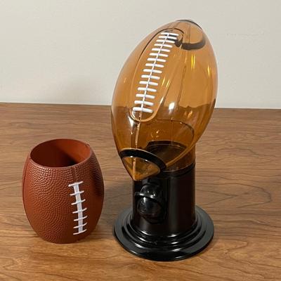 LOT 100L: Football Themed Home Decor, Party Essentials, Serving Pieces, Football-Shaped Crockpot and More