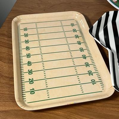 LOT 100L: Football Themed Home Decor, Party Essentials, Serving Pieces, Football-Shaped Crockpot and More