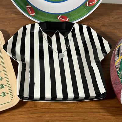 LOT 100L: Football Themed Home Decor, Party Essentials, Serving Pieces, Football-Shaped Crockpot and More