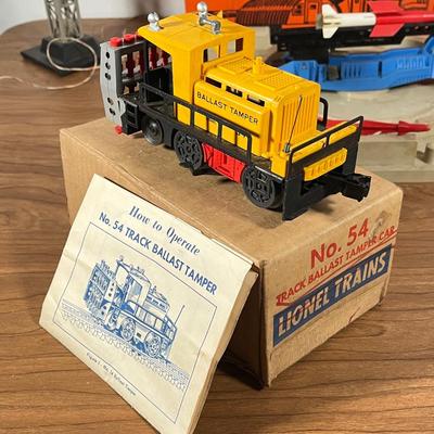 LOT 117L: Collection of Vintage Lionel Trains - Missile Launching Platform and Train Car, Exploding Ammunition Dump and More