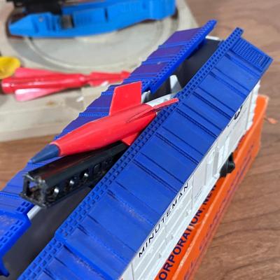 LOT 117L: Collection of Vintage Lionel Trains - Missile Launching Platform and Train Car, Exploding Ammunition Dump and More