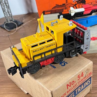 LOT 117L: Collection of Vintage Lionel Trains - Missile Launching Platform and Train Car, Exploding Ammunition Dump and More
