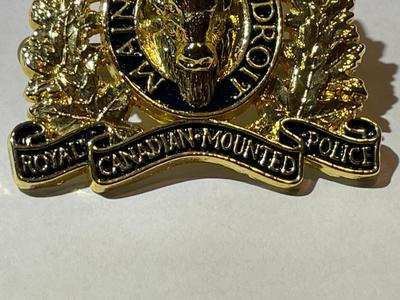 Scarce RCMP Royal Canadian Mounted Police Cap Badge -Gilt & Enameled in VG Preowned Condition.