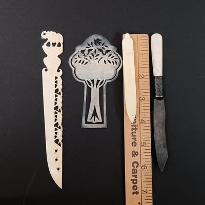 LOT 436: A Little Museum Collection- Folding Metal Book End, Stylized Letter Openers, Woven Shawl, Beaded Hummingbird & More