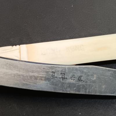 LOT 436: A Little Museum Collection- Folding Metal Book End, Stylized Letter Openers, Woven Shawl, Beaded Hummingbird & More