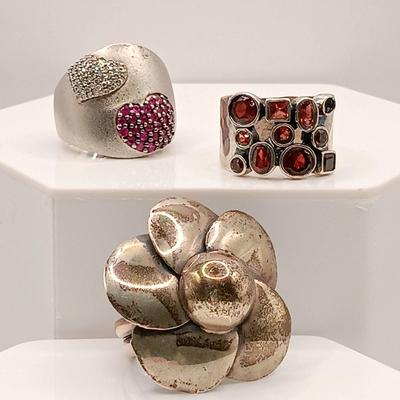 LOT 26: BH 925 Sterling Heart Ring 13.39g, 950 Flower Ring 10.73g & Israel 925 Ring with Garnet-Tone Stones 7.94g