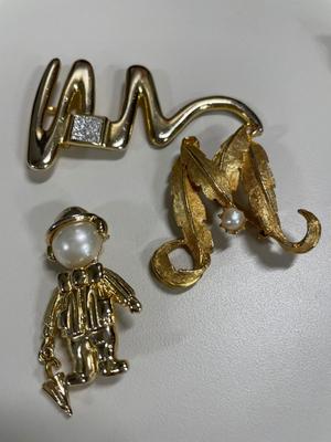 Signed gold tone brooches