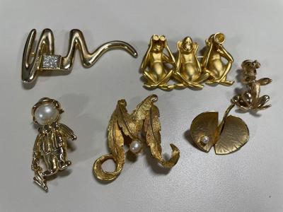 Signed gold tone brooches