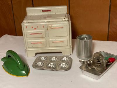 Tin toy stove with children’s baking toys
