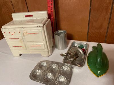 Tin toy stove with children’s baking toys