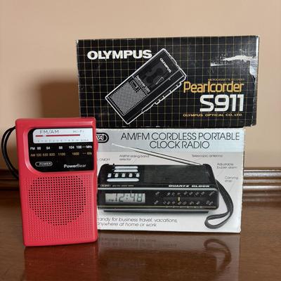 LOT 104: Transistor Radios, Sylvania Portable DVD Player, Olympus Pearlcorder, Am/Fm Cordless Portable Alarm Clock Radio