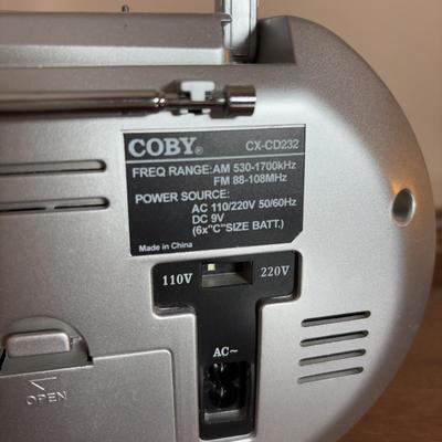 LOT 104: Transistor Radios, Sylvania Portable DVD Player, Olympus Pearlcorder, Am/Fm Cordless Portable Alarm Clock Radio