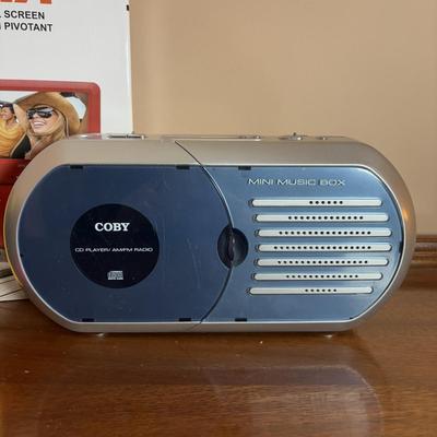 LOT 104: Transistor Radios, Sylvania Portable DVD Player, Olympus Pearlcorder, Am/Fm Cordless Portable Alarm Clock Radio