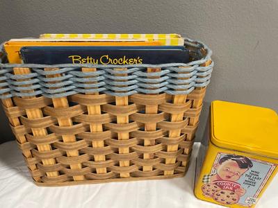 Basket with vintage cookbooks and tin