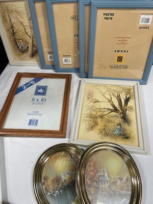 Wall decor and frames in a blue tote with lid