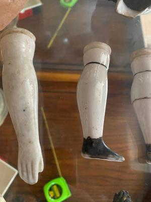 ANTIQUE DOLL HEADS AND LIMBS