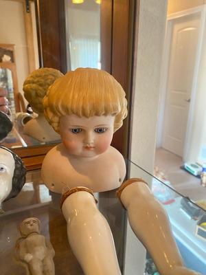 ANTIQUE DOLL HEADS AND LIMBS