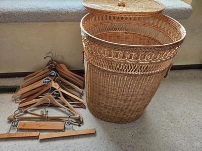 Wicker laundry hamper with wooden clothes hangers