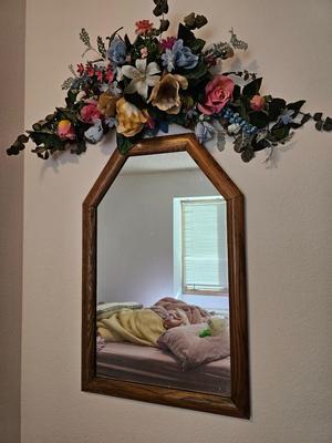 Wall mirror with dried floral decor