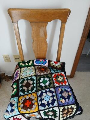 Vintage wicker seat dining room chair and an Afghan shawl