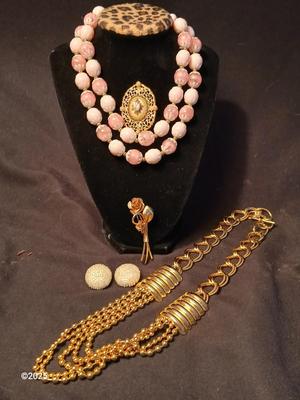 Two fashion necklaces with brooches and earrings