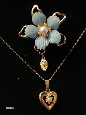 Heart pendant with pearl in the center and a vintage flower brooch