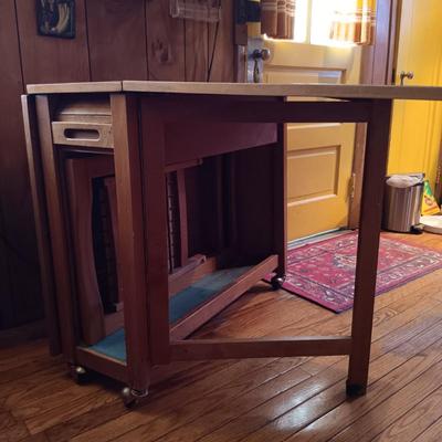 LOT 286: Romanian Made MCM Hideaway Drop Leaf Table w/ 5 Folding Chairs