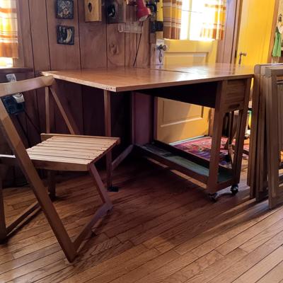 LOT 286: Romanian Made MCM Hideaway Drop Leaf Table w/ 5 Folding Chairs