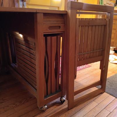 LOT 286: Romanian Made MCM Hideaway Drop Leaf Table w/ 5 Folding Chairs