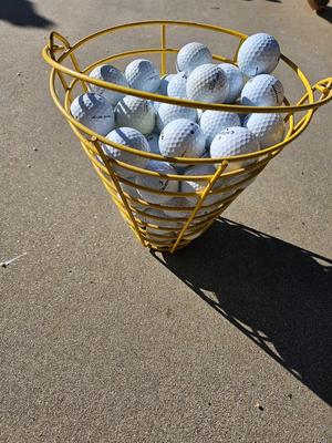 Golf balls in heavy metal golf ball range basket 3 of 4