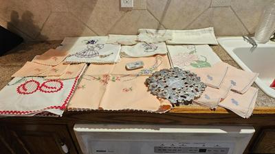 Vintage embroidered kitchen linens and a Royal eight-inch expandable trivet