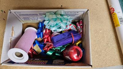 A bunch of Holiday ribbon and wrapping paper and ribbon