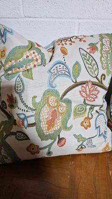 Wrought Iron basket with candles and two throw pillows