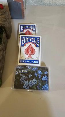 Cool Summit trail cribbage board and an assortment of playing cards and travel games