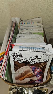 Box of sewing patterns, Singer sewing machine attachments, and assortment of other sewing needs