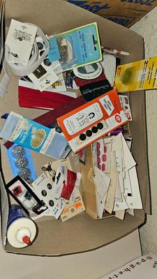 Box of sewing patterns, Singer sewing machine attachments, and assortment of other sewing needs