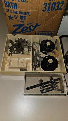 Box of sewing patterns, Singer sewing machine attachments, and assortment of other sewing needs