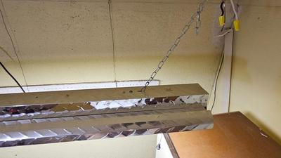 Pegboard with hardware and a nice free hanging shop light