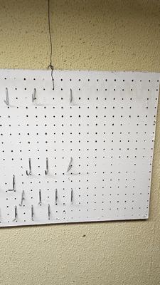 Pegboard with hardware and a nice free hanging shop light