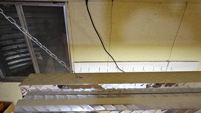 Pegboard with hardware and a nice free hanging shop light